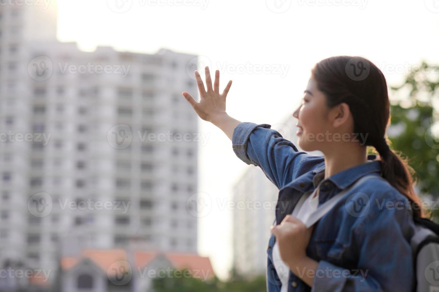 Confident young female student in formal clothes outfit walking in the city park, photo