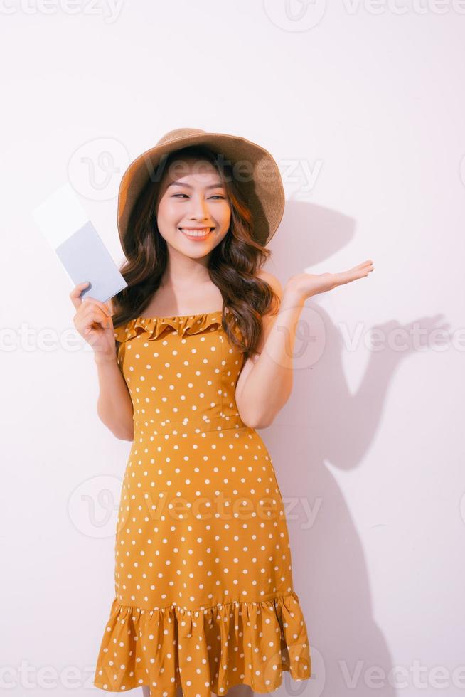 Travel concept portrait of smiling woman holding passport with ticket showing copy paste photo