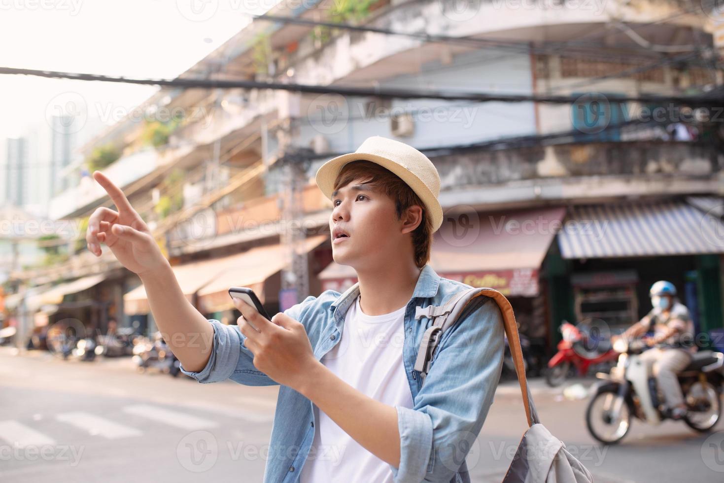 Young man hipster traveling with backpack and hat, photo
