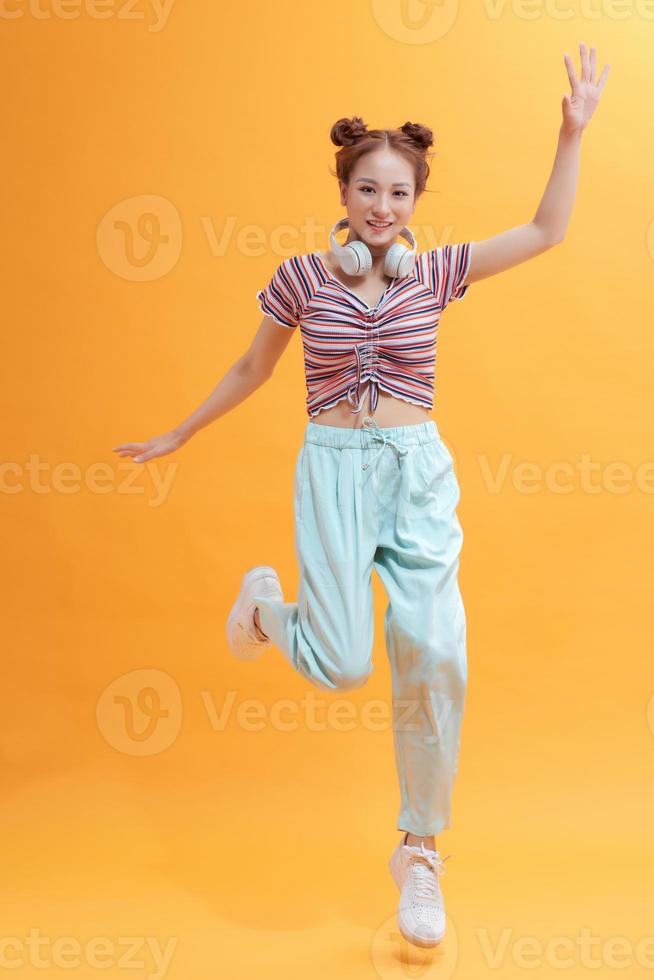 happy asian woman dancing and jumping from happiness photo