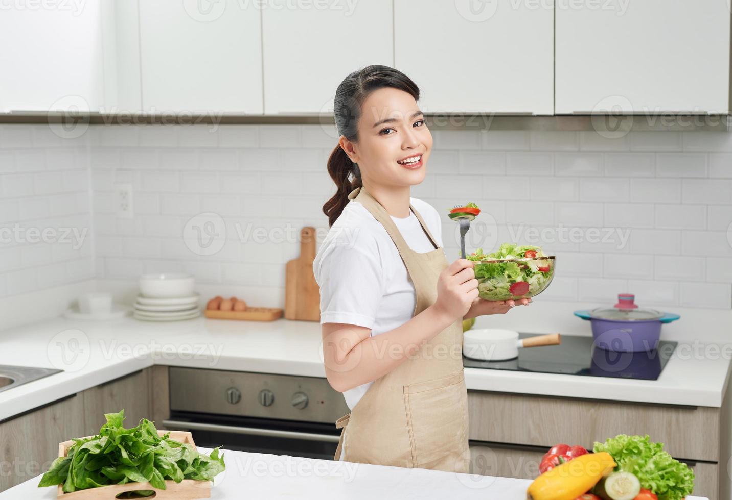 Vegan lifestyle. Healthy nutrition. Female with fresh vegetables salad bowl. Happy young housewife. photo