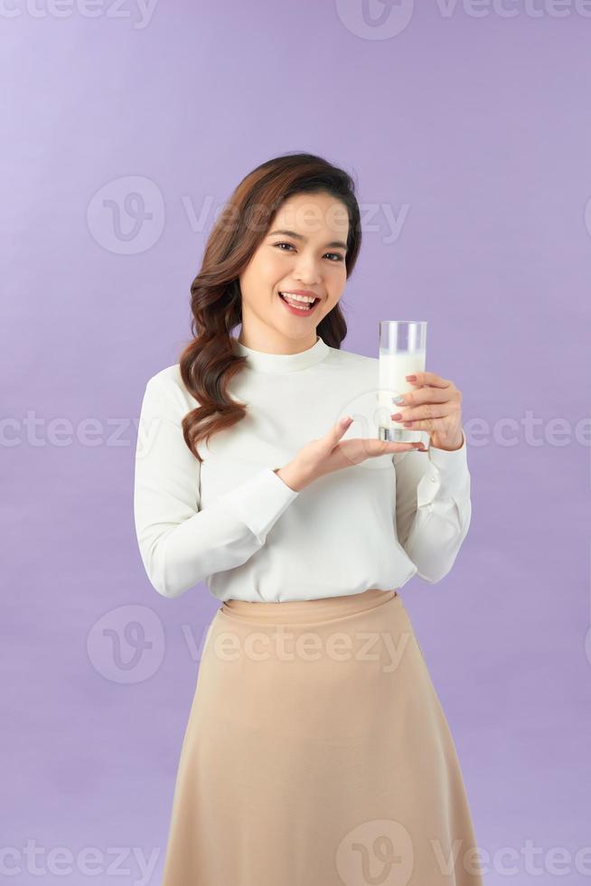 Wellness beauty woman holding a glass of milk in her hand photo