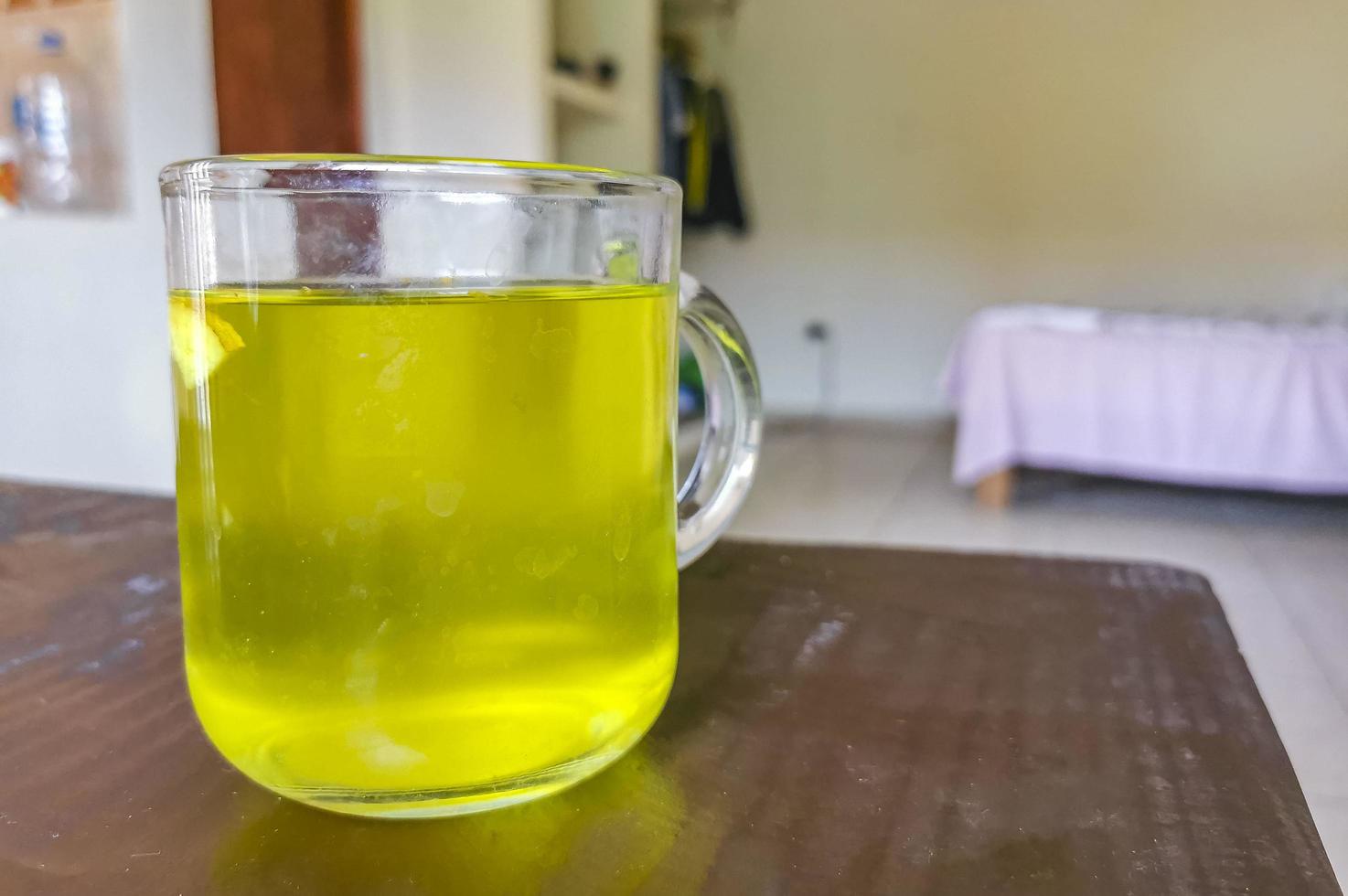 Glass or cup pot with hot ginger tea. photo