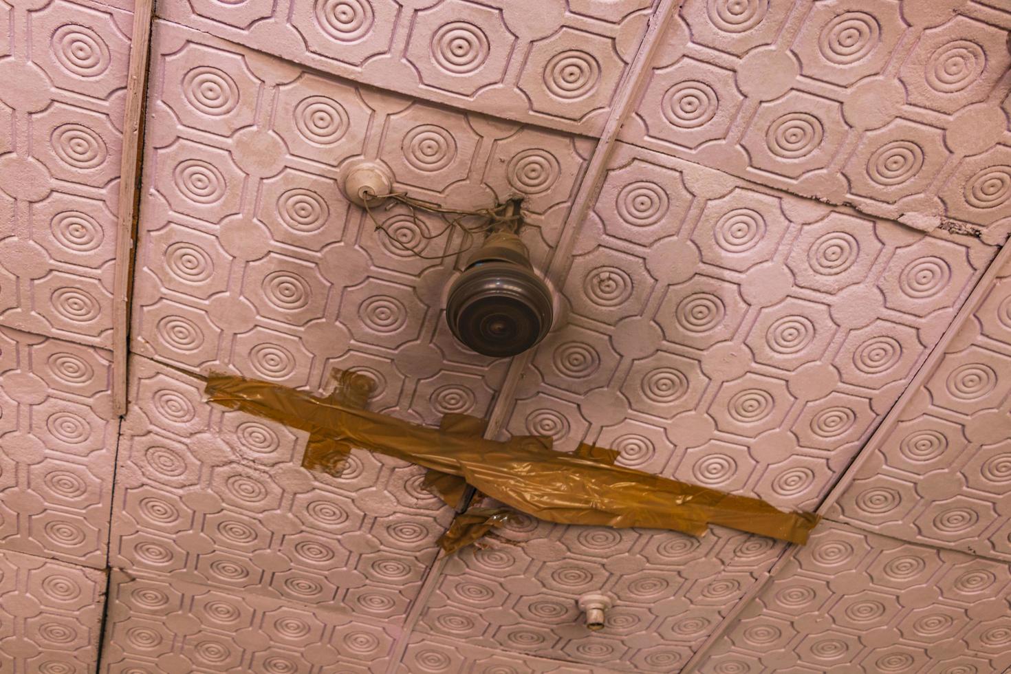 Broken ceiling and fan at roof Agra India. photo