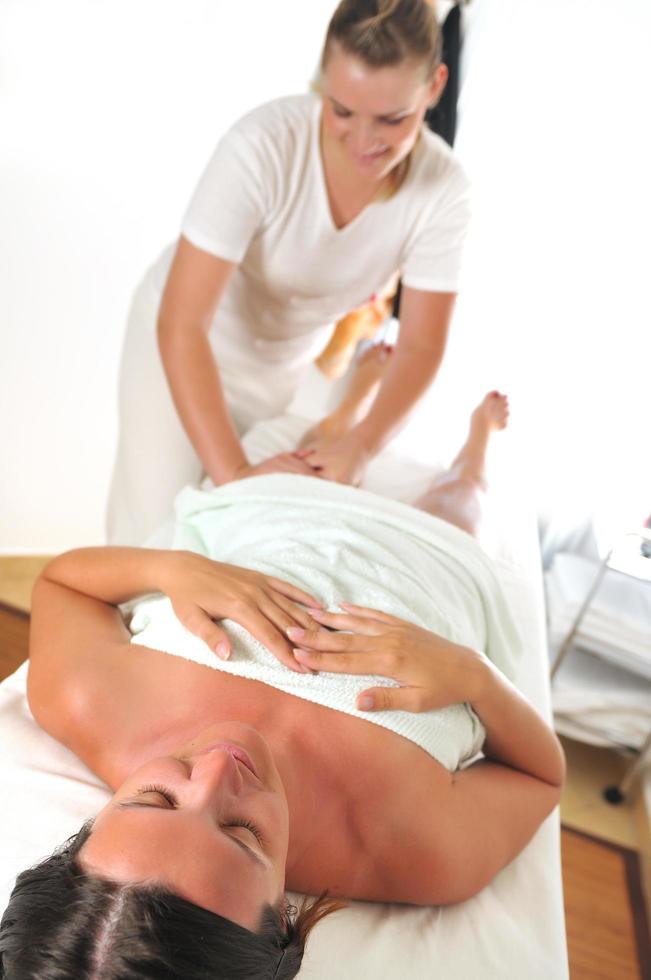 beautiful woman having leg and foot massage at the spa and welln photo