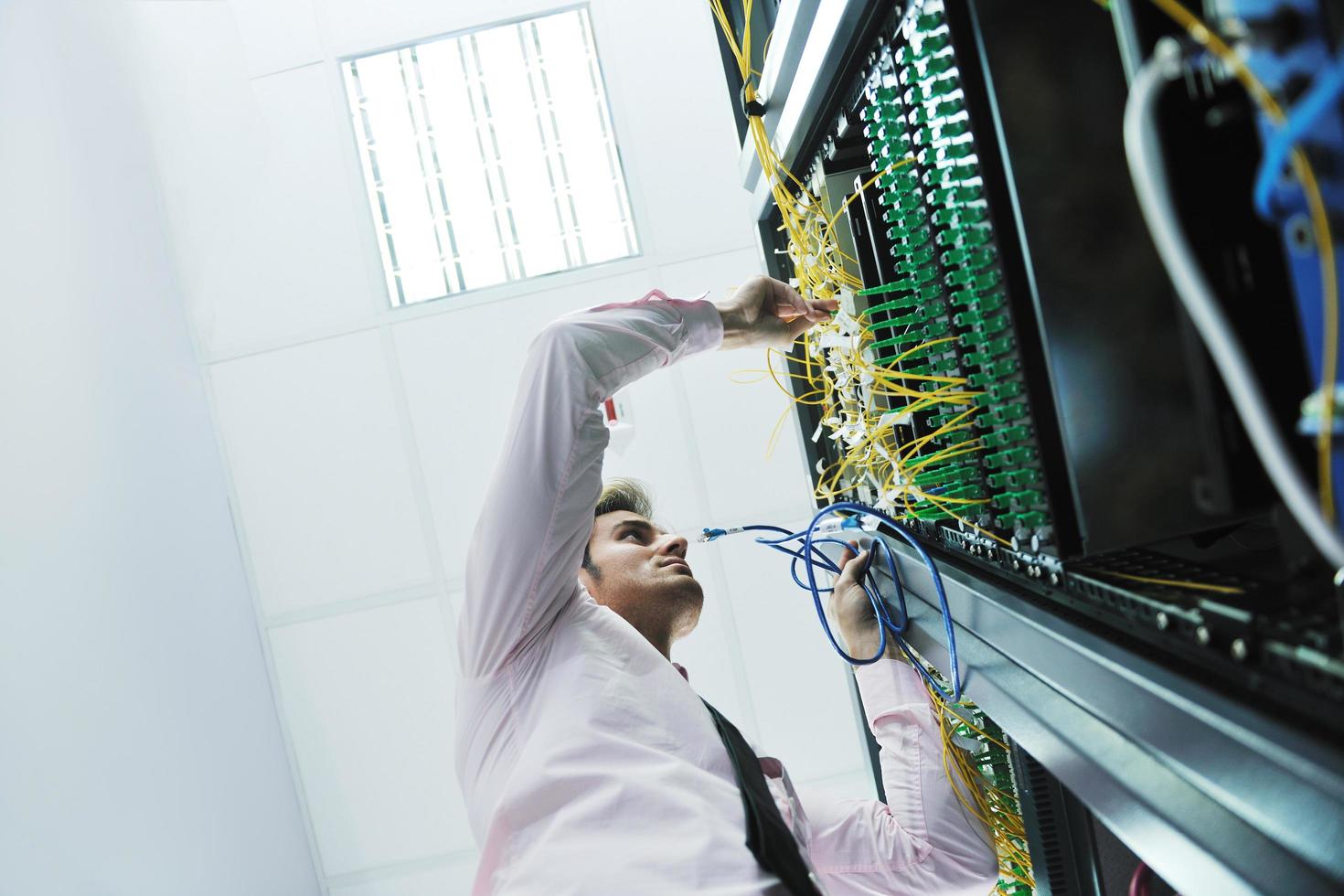 young it engeneer in datacenter server room photo