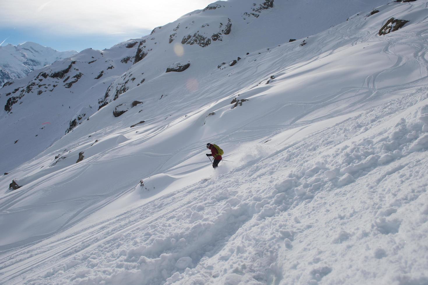 freeride skier skiing in deep powder snow photo