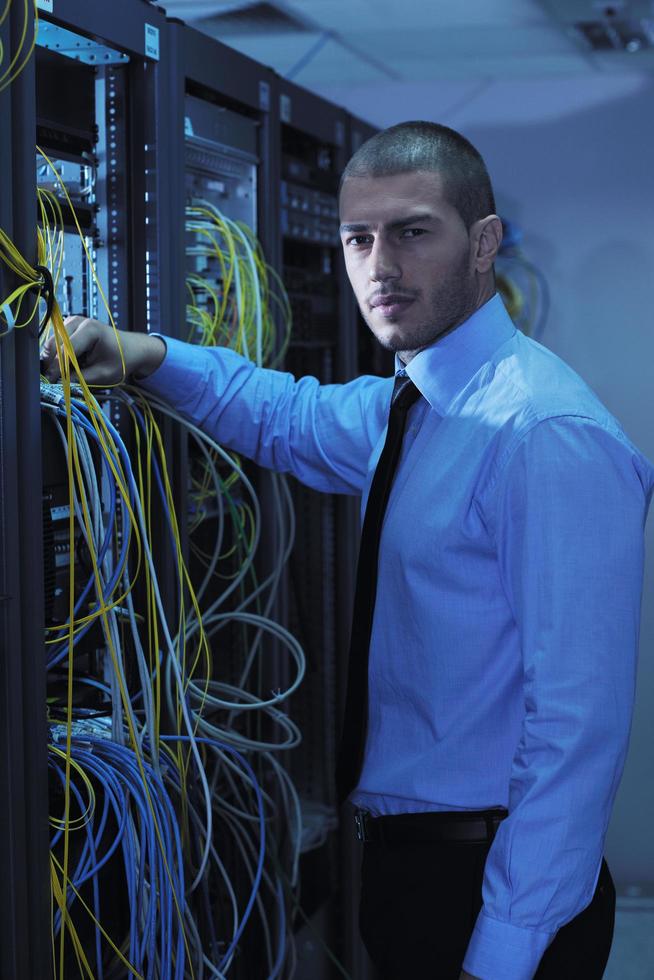 young it engineer in datacenter server room photo