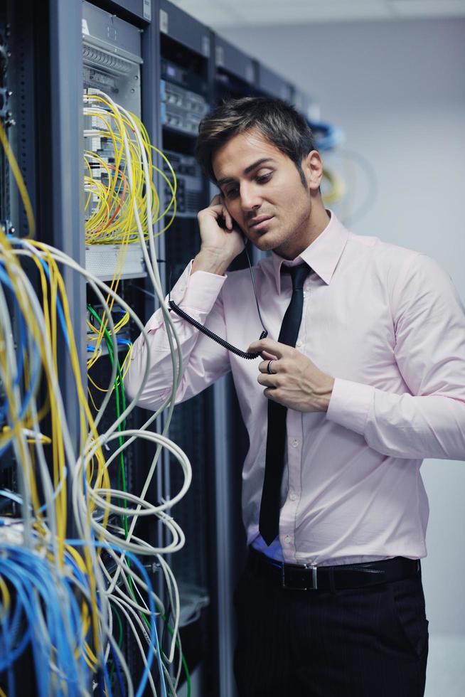 it engeneer talking by phone at network room photo
