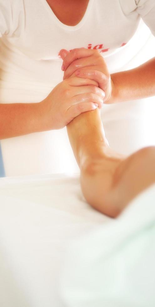 beautiful woman having leg and foot massage at the spa and welln photo