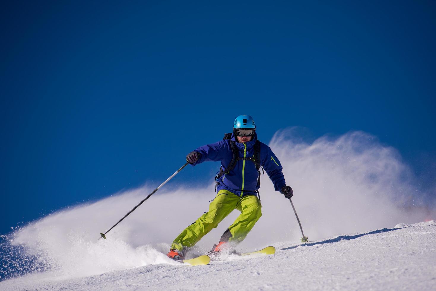 Skier having fun while running downhill photo