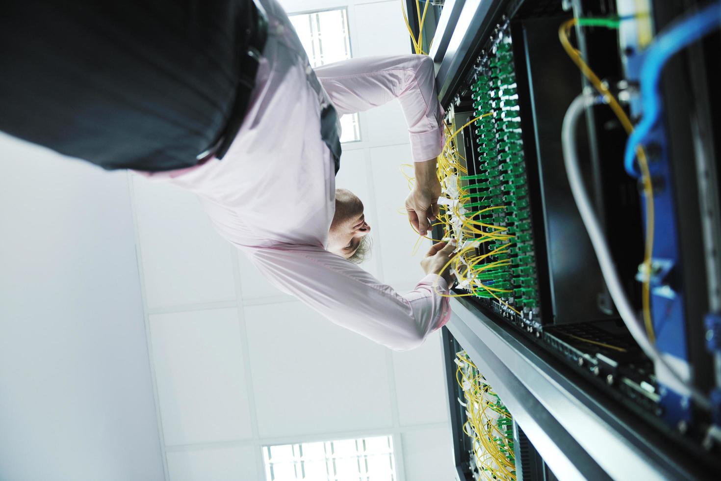 young it engeneer in datacenter server room photo