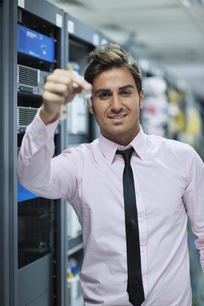 young it engineer in datacenter server room photo