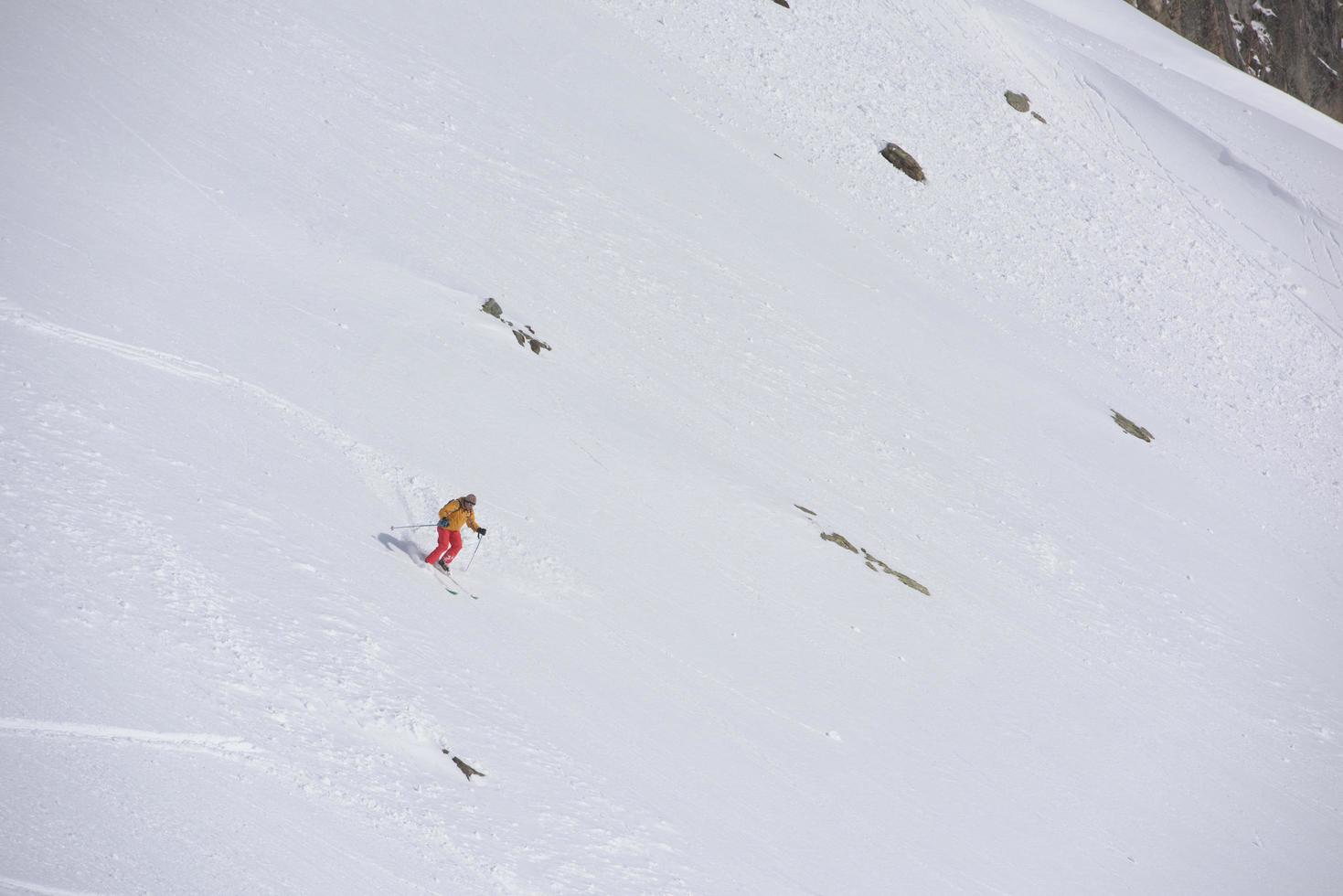 freeride skier skiing in deep powder snow photo