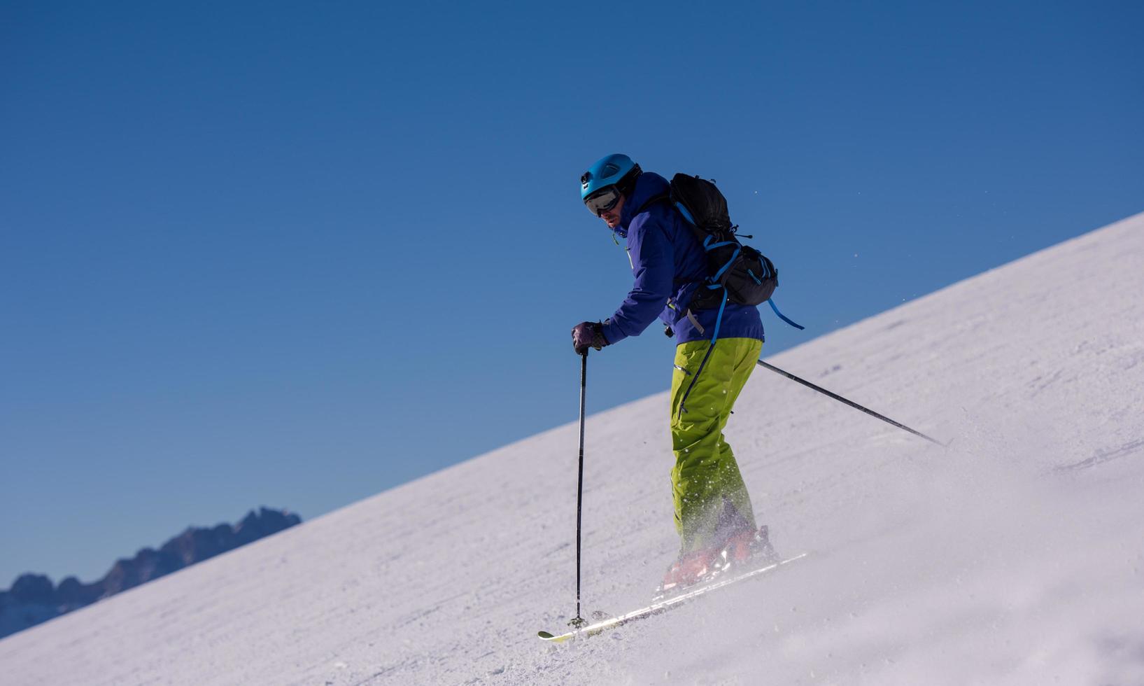 Skier having fun while running downhill photo