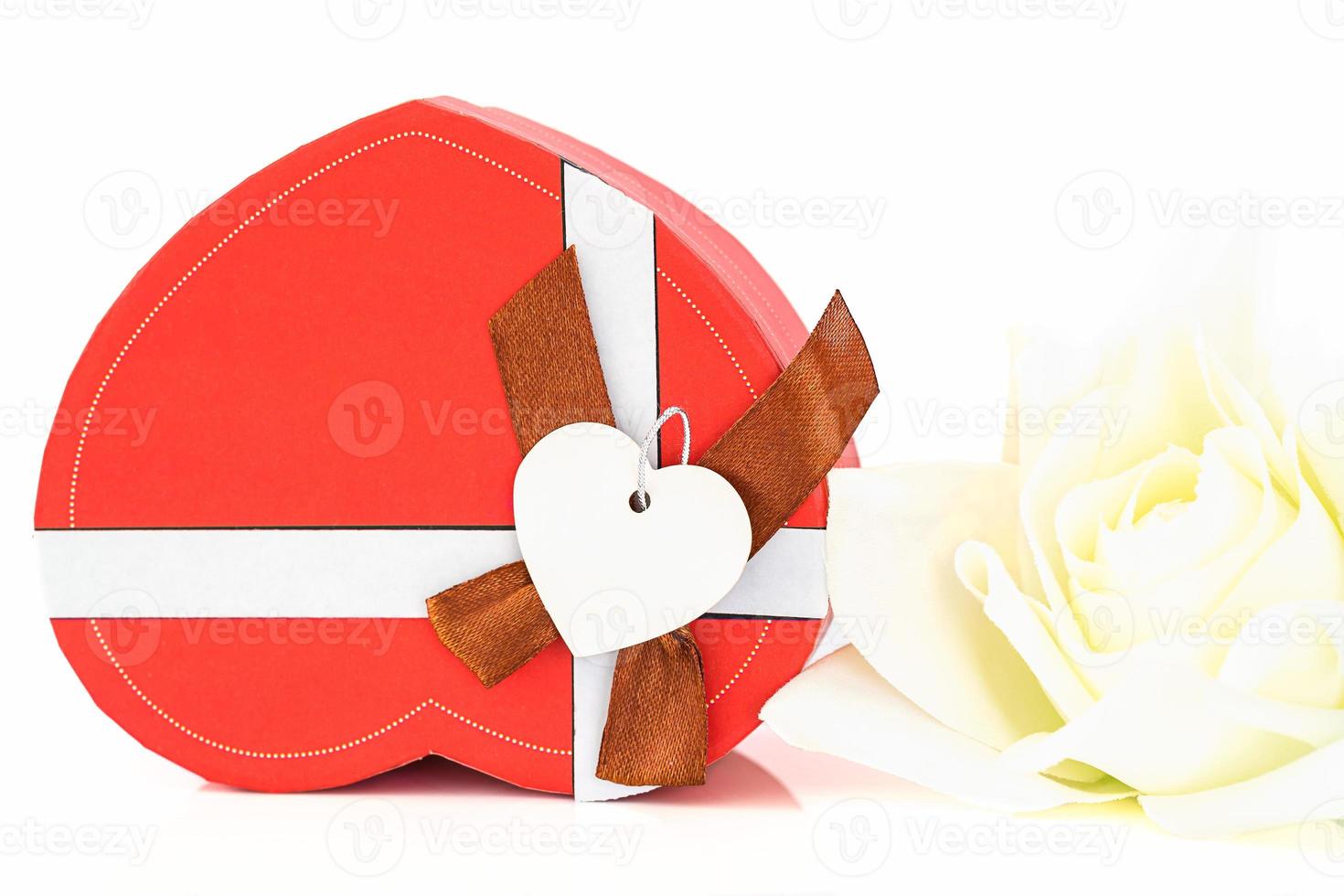Close up white rose and heart shaped box on white photo