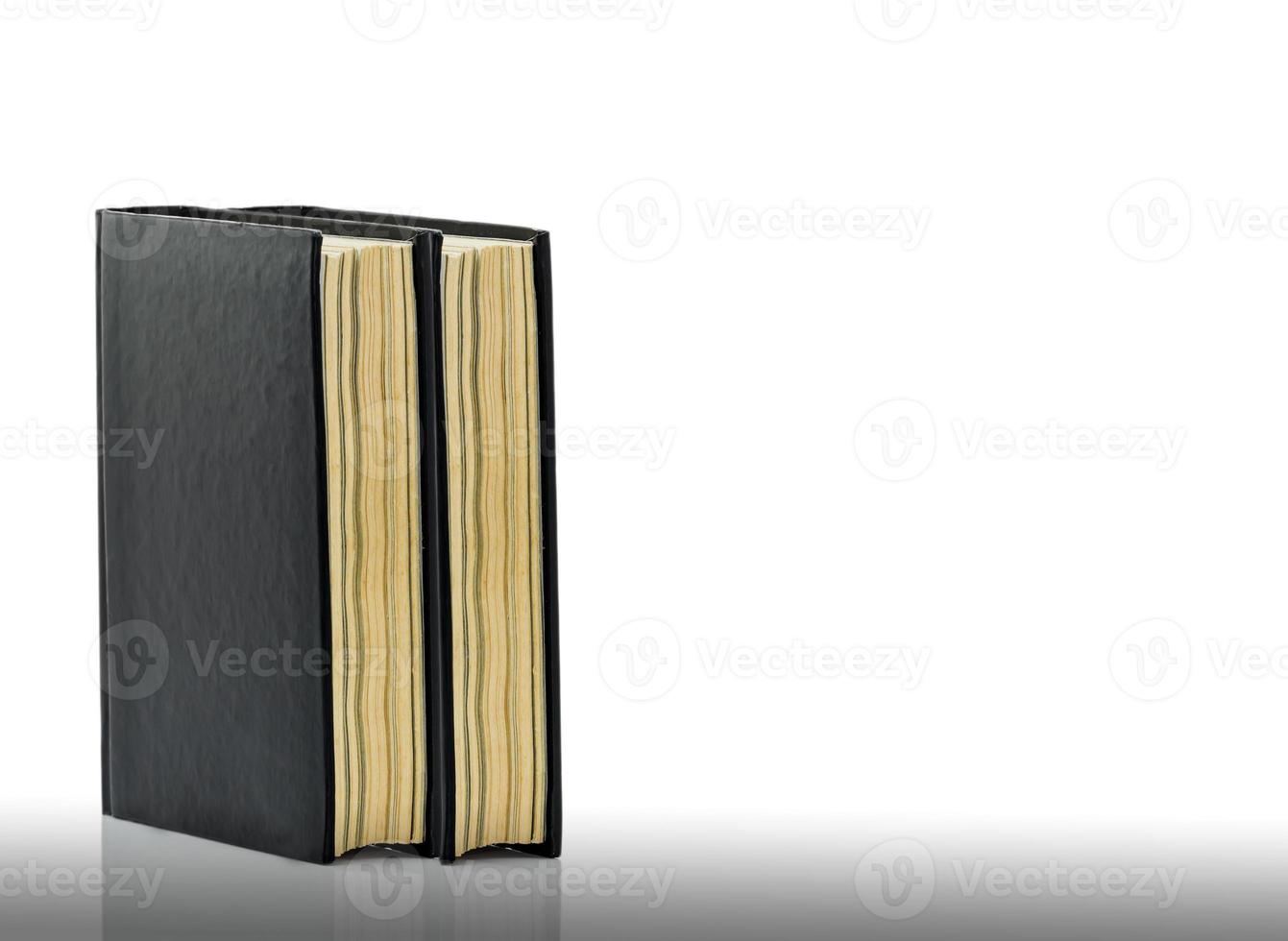 Closed black book is laying on white background photo