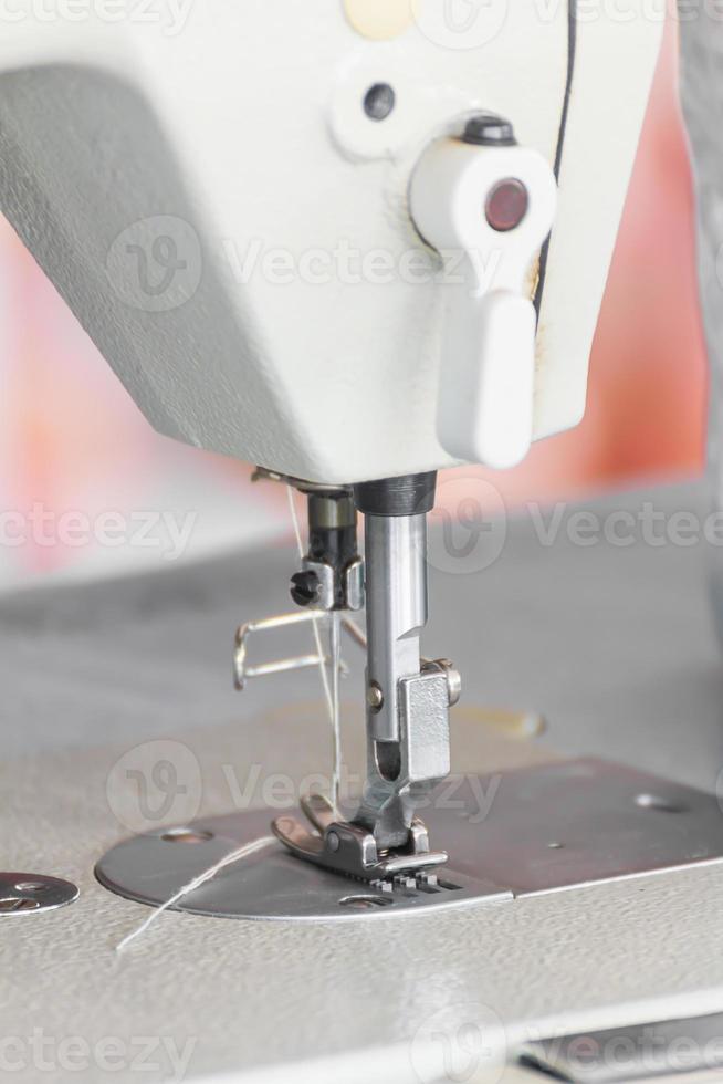 Close up industrial sewing machine photo