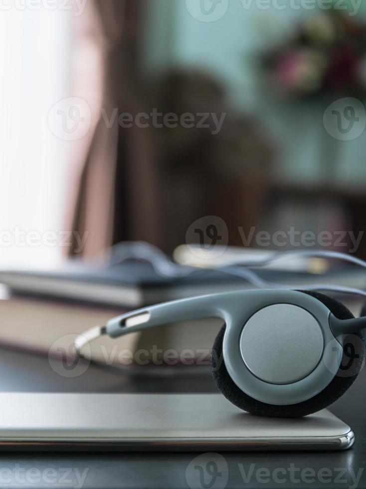 Headphones with book and mobile phone photo