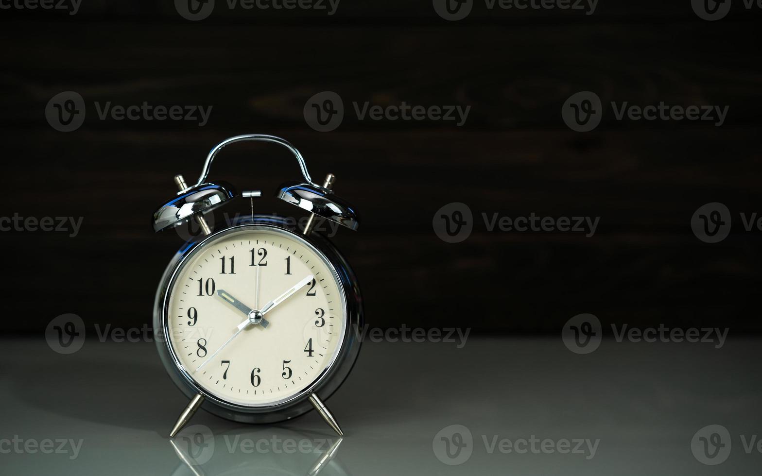 Retro alarm clock on table photo