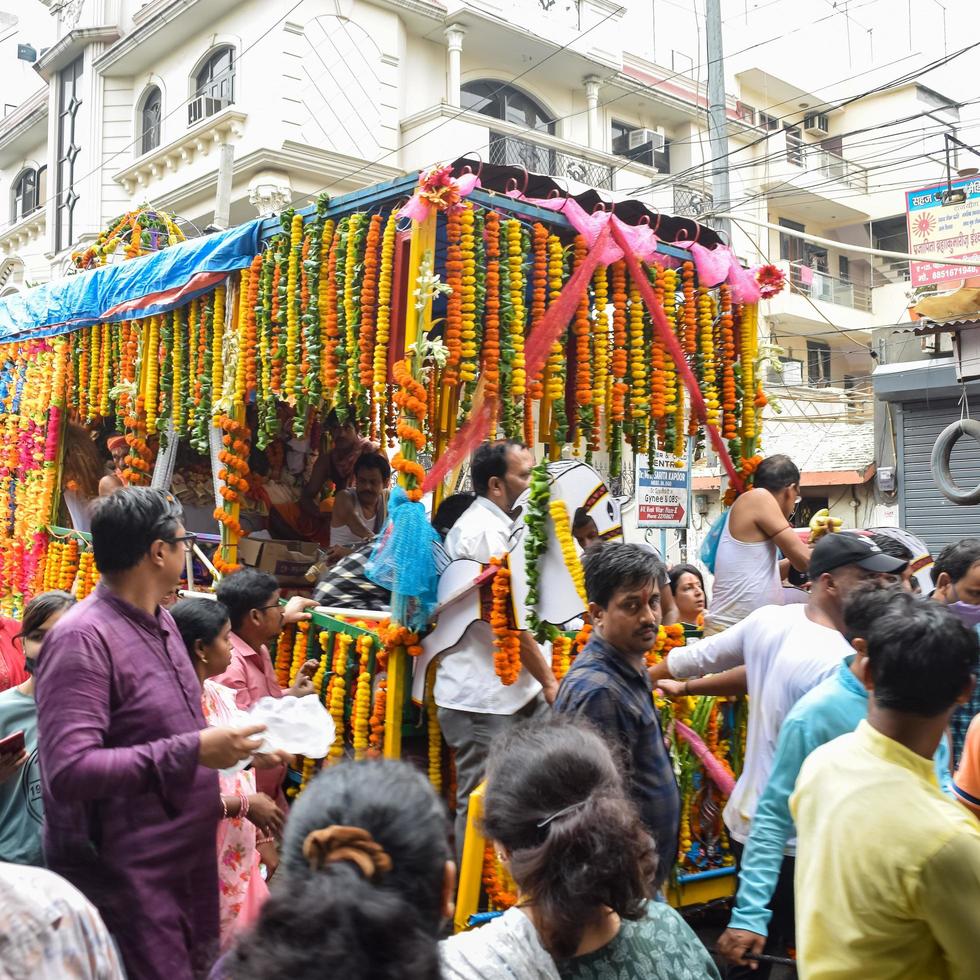 New Delhi, India July 01 2022 - A huge gathering of devotees from different parts of Delhi on the occasion of ratha yatra or rathyatra. Rath for Lord Jagannath pulled by people, Jagannath Rath Yatra photo