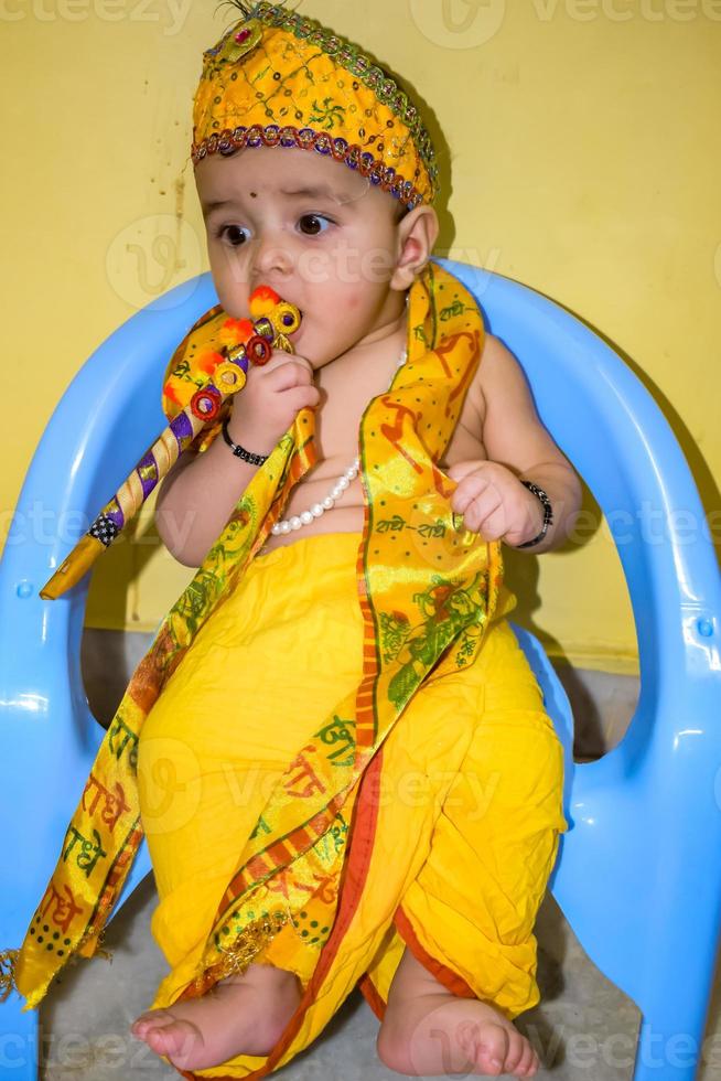 Cute Indian Kid dressed up as little Lord Krishna on the occasion of Radha Krishna Janmastami Festival in Delhi India photo