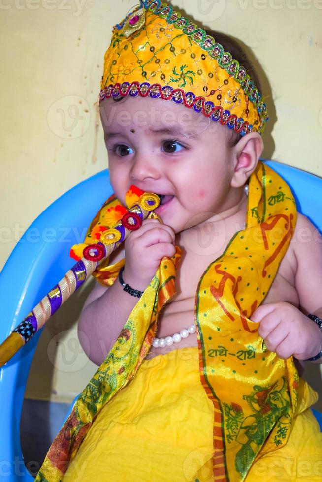 Cute Indian Kid dressed up as little Lord Krishna on the occasion of Radha Krishna Janmastami Festival in Delhi India photo