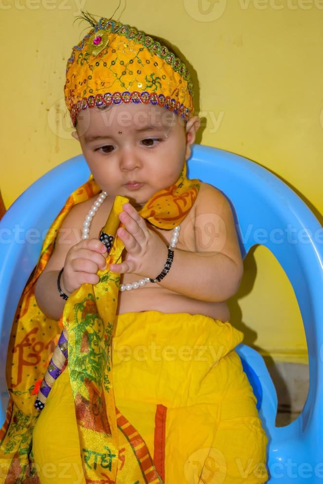 Cute Indian Kid dressed up as little Lord Krishna on the occasion of Radha Krishna Janmastami Festival in Delhi India photo