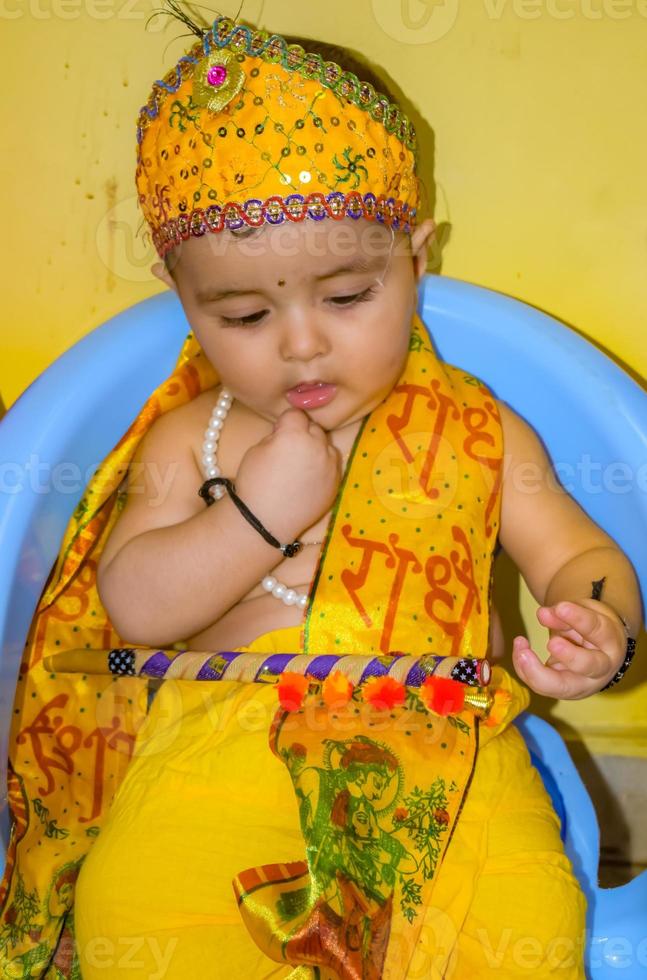 Cute Indian Kid dressed up as little Lord Krishna on the occasion of Radha Krishna Janmastami Festival in Delhi India photo