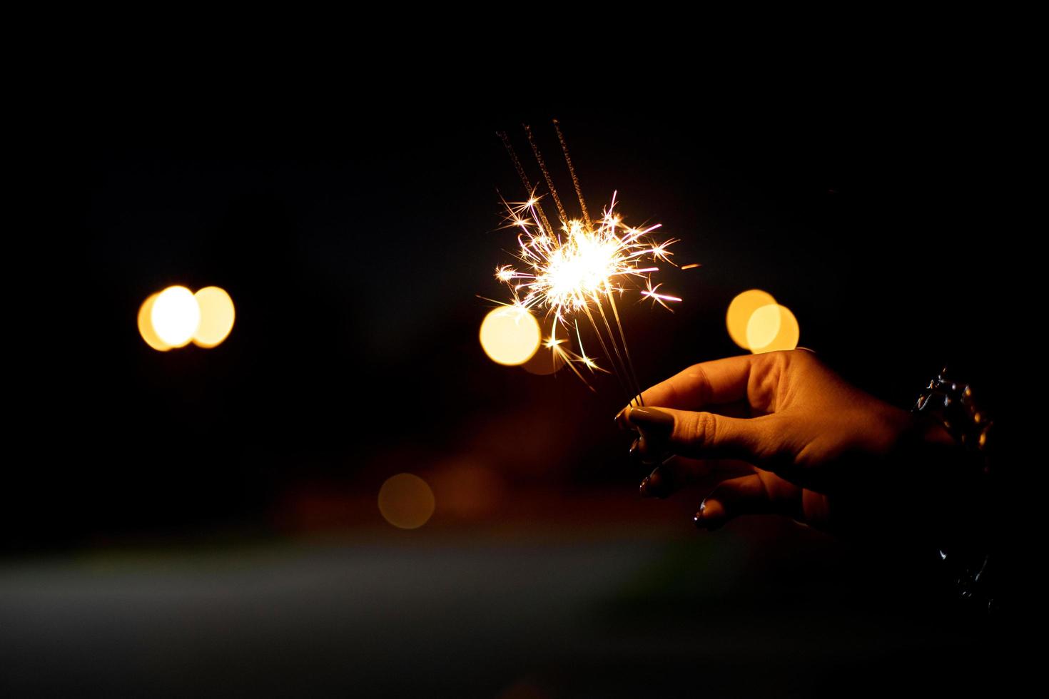 Person Holding a Festive Sparkler HD photo