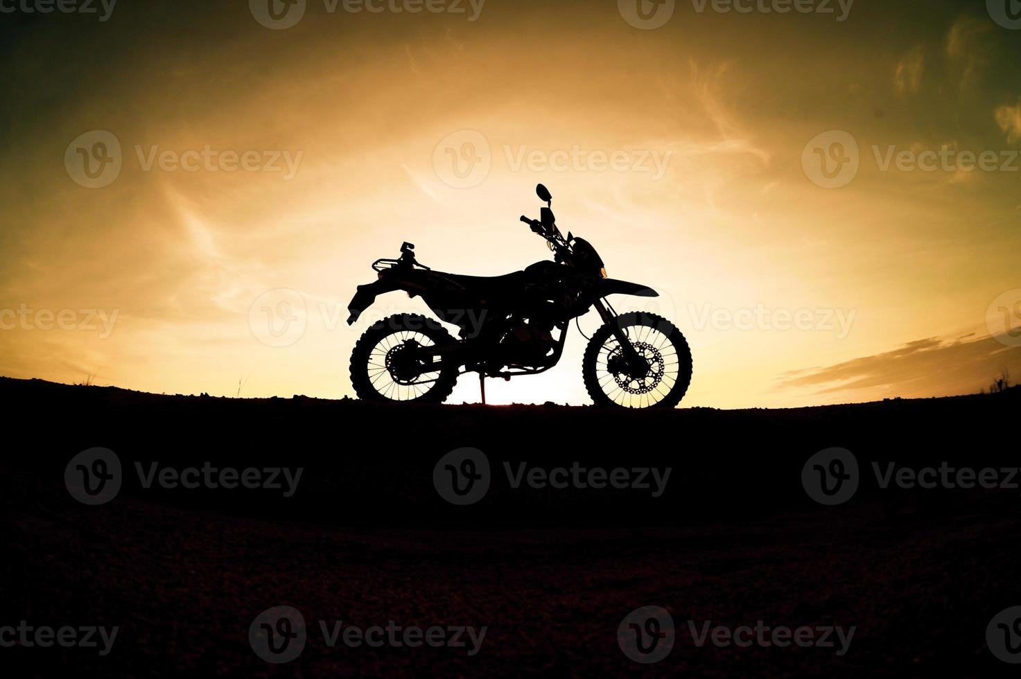 Tourist motorcycle motocross silhouette Park on the mountain in the evening. adventure travel concept photo