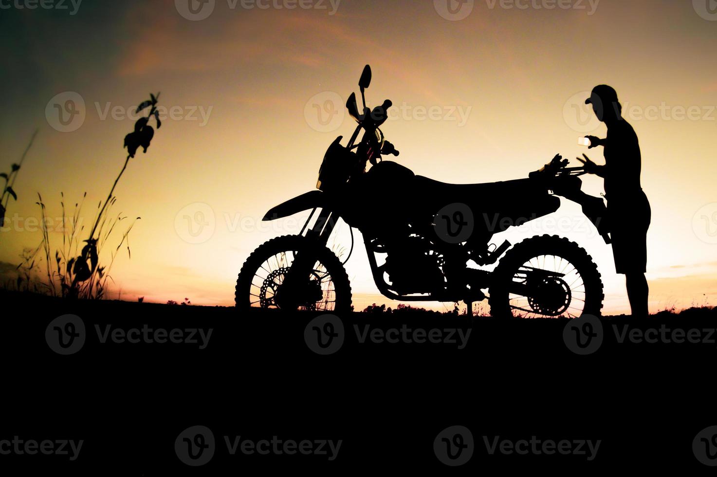 Men's silhouettes and touring motocross bikes. Park to relax in the mountains in the evening. adventure travel and leisure concept photo