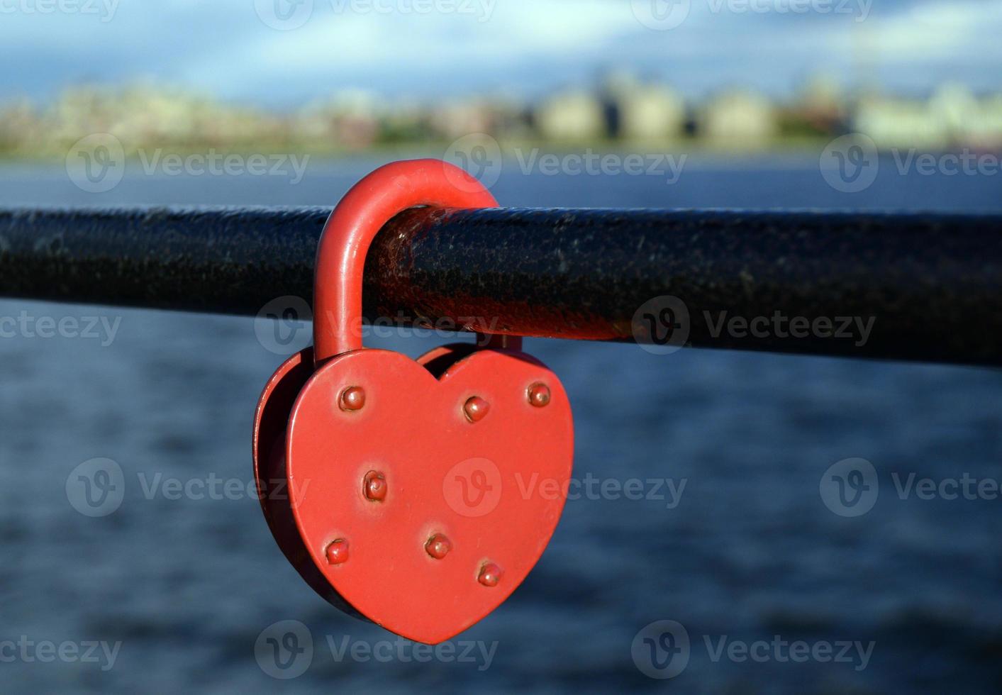 Heart shapeed lock - a symbol of love on the embankment photo