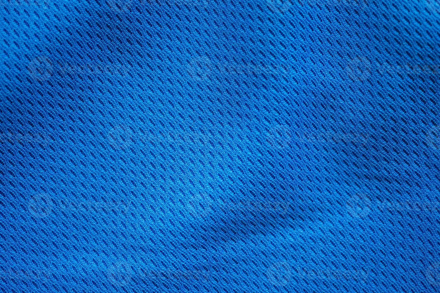 Blue fabric sport clothing football jersey with air mesh texture background photo