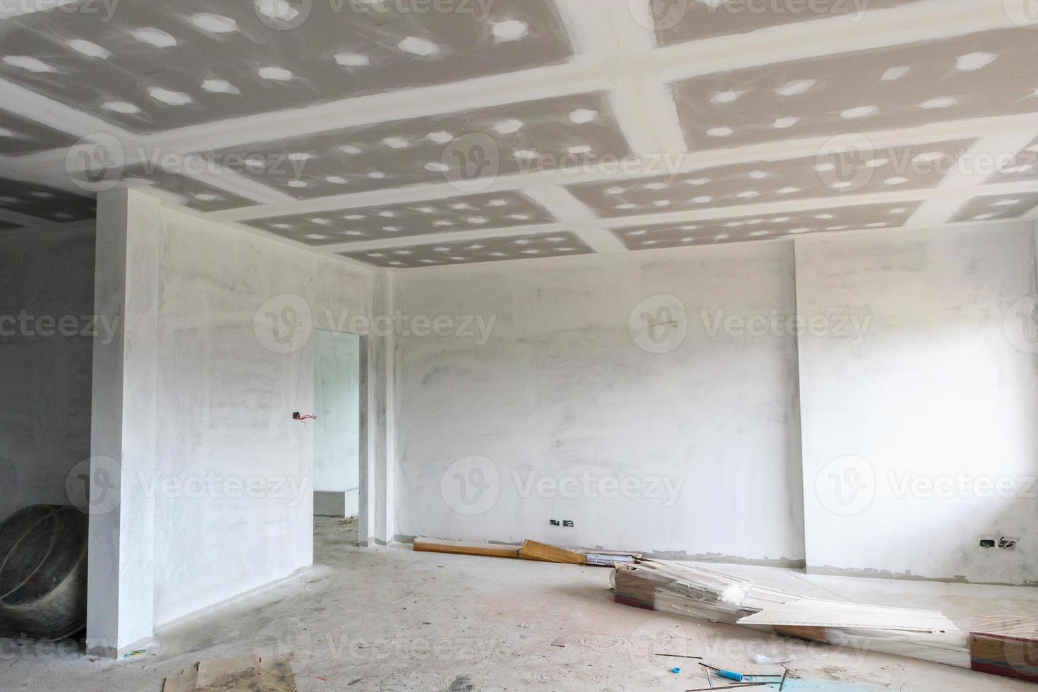Empty room interior with gypsum board ceiling at construction site photo