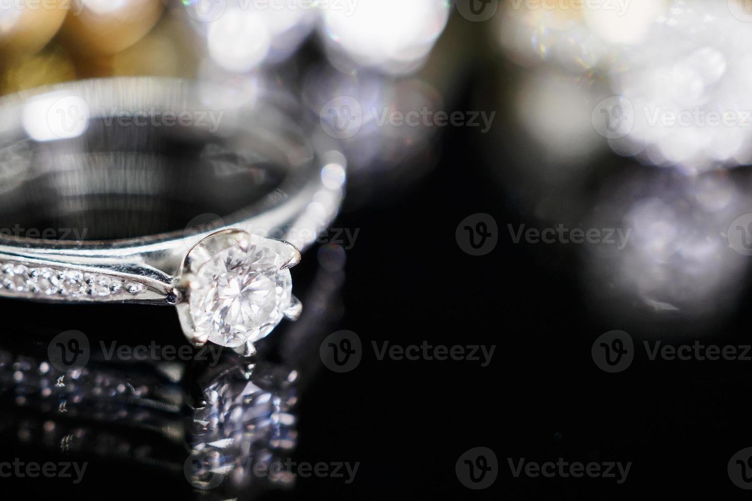 anillos de diamantes de joyería con una reflexión sobre fondo negro foto