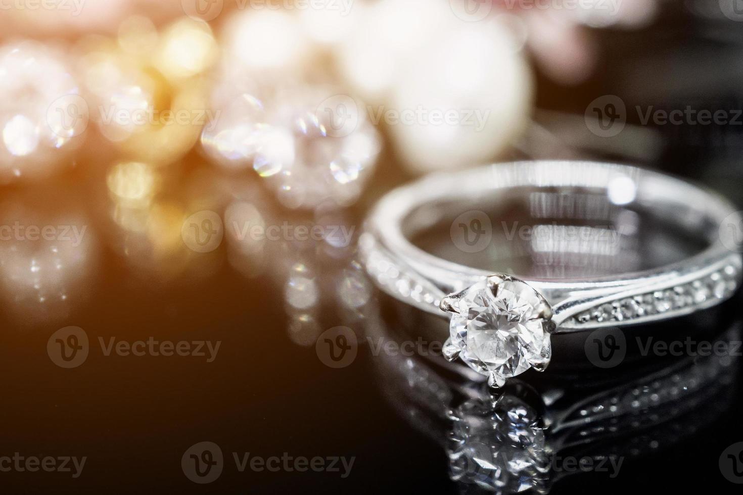 Jewelry diamond rings with reflection on black background photo