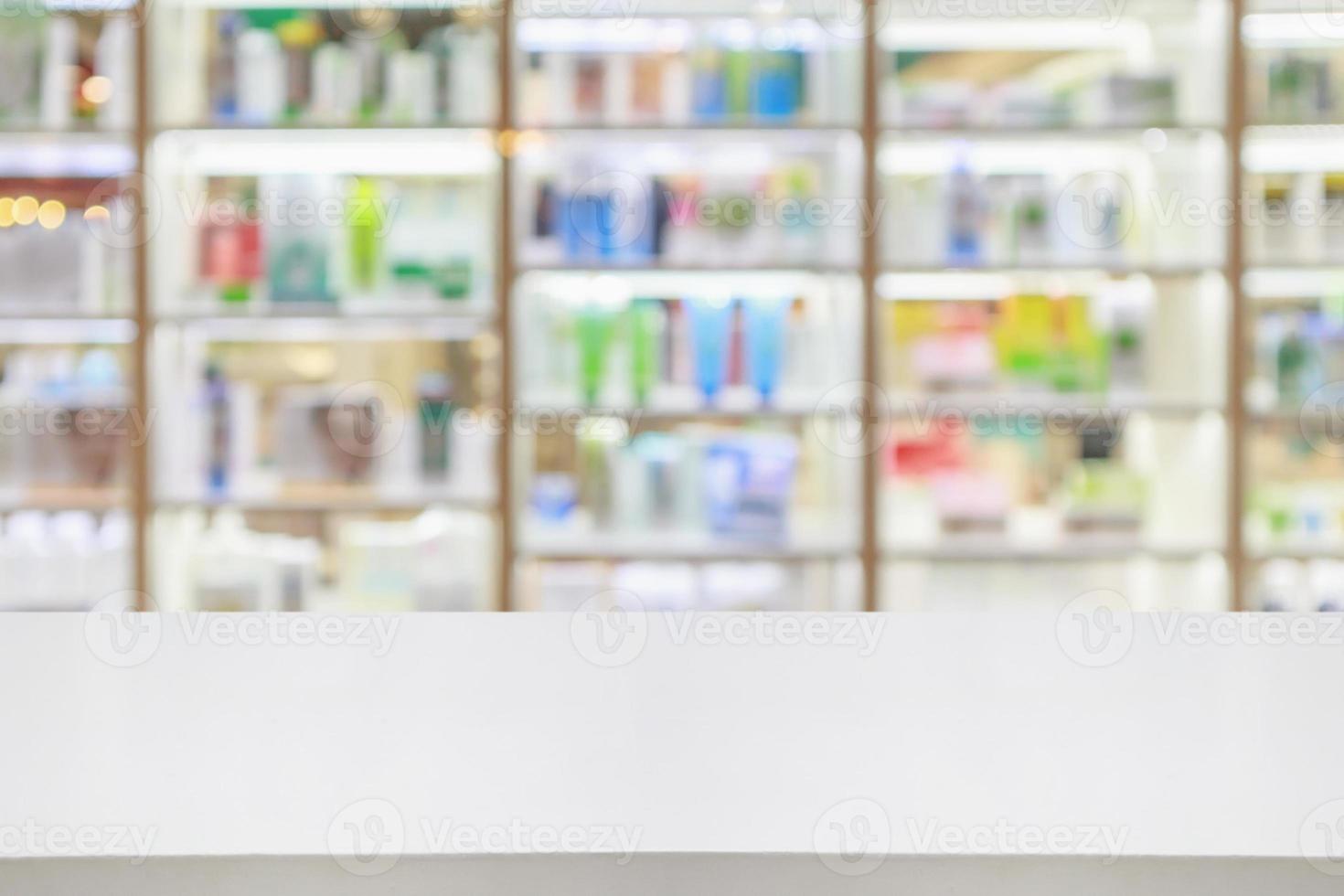 Pharmacy counter with medicines healthcare product arranged on shelves in drugstore blurred defocused background photo