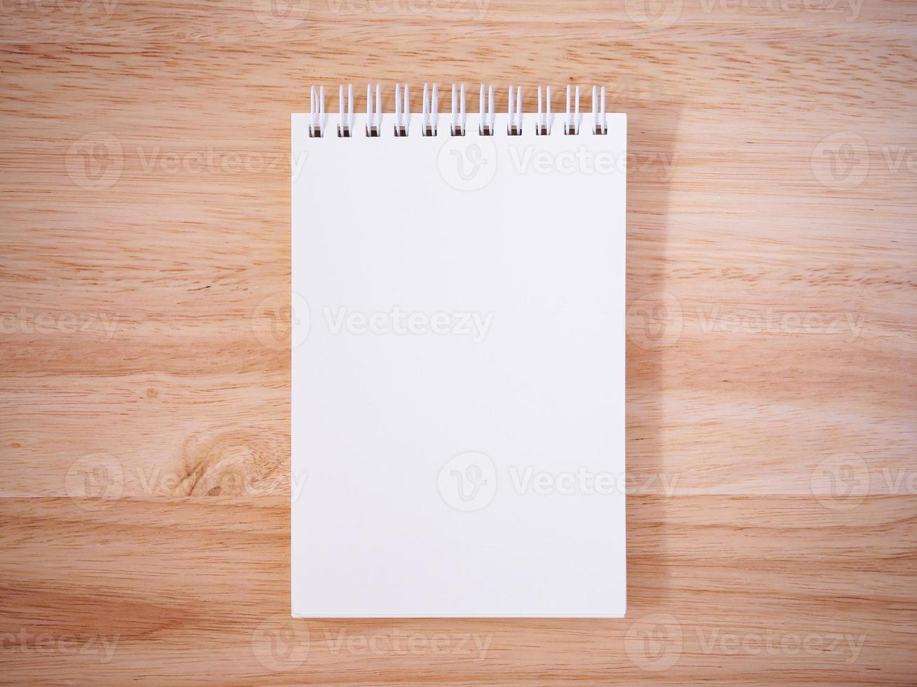Notepad on the wooden desk table photo