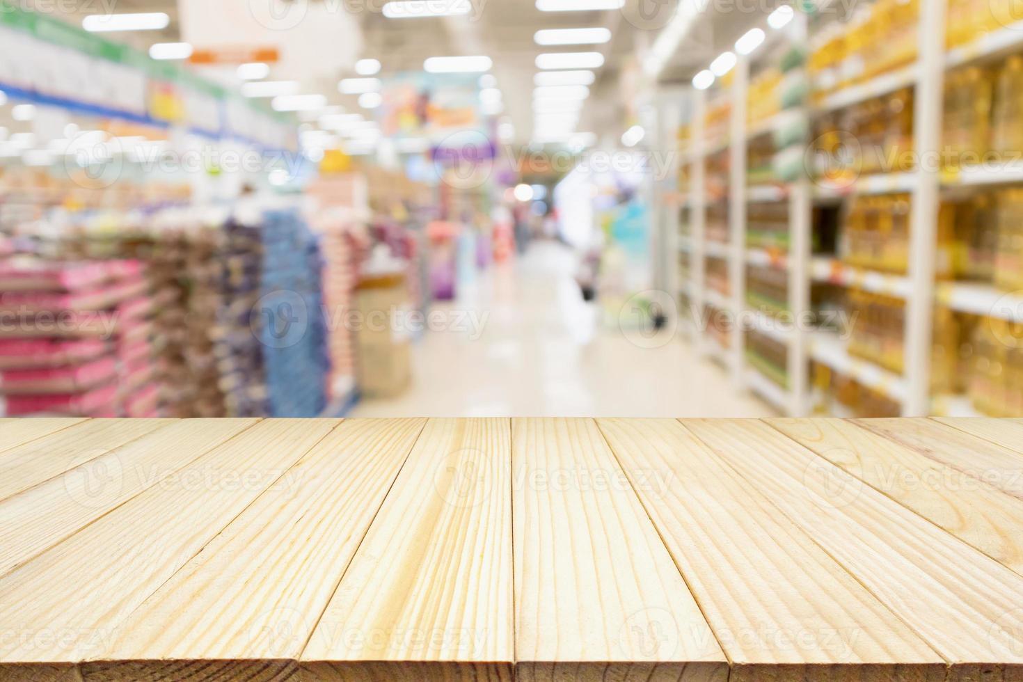 Wood table top product display with Abstract blur Supermarket aisle with rice in packaging for sale and vegetable oil bottles on shelves background photo