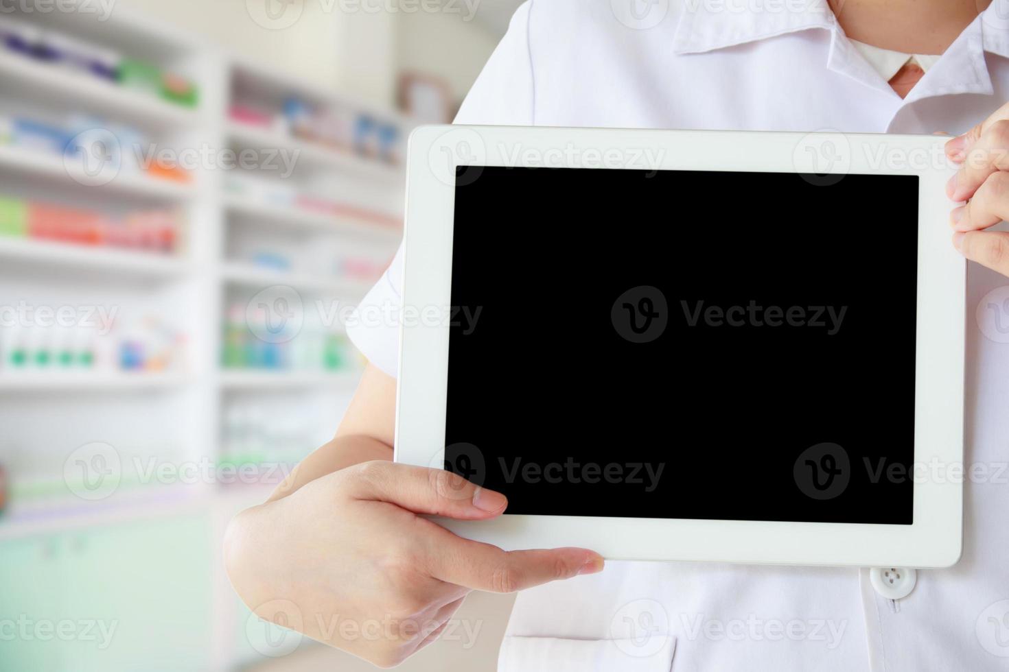 pharmacist showing promotion displaying the blank screen of tablet computer photo
