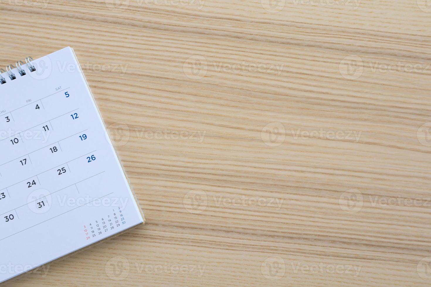 calendar page on wood table background photo