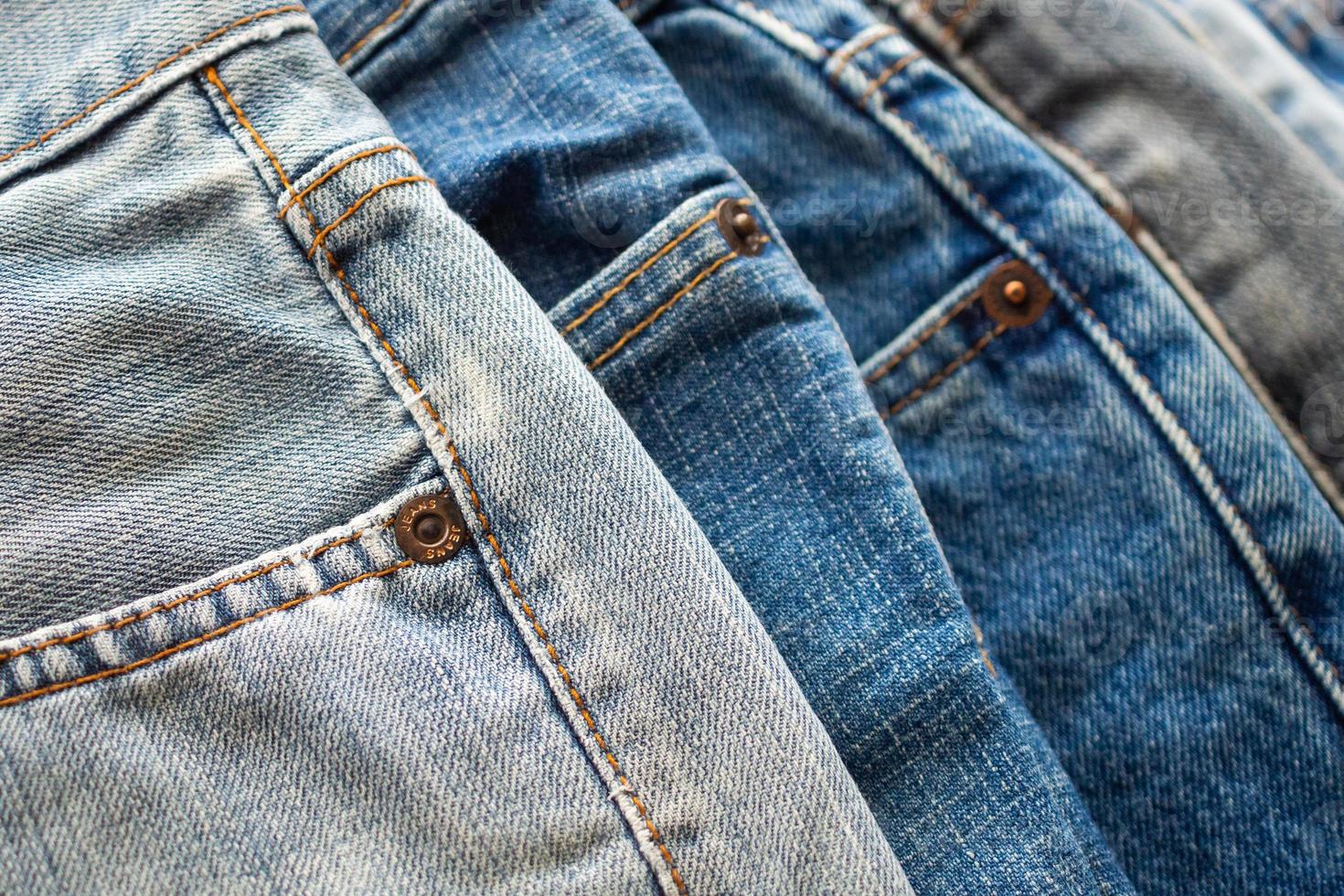 denim blue jeans stack texture background closeup photo