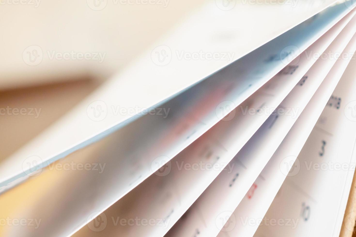 Abstract blur calendar page flipping sheet close up background photo