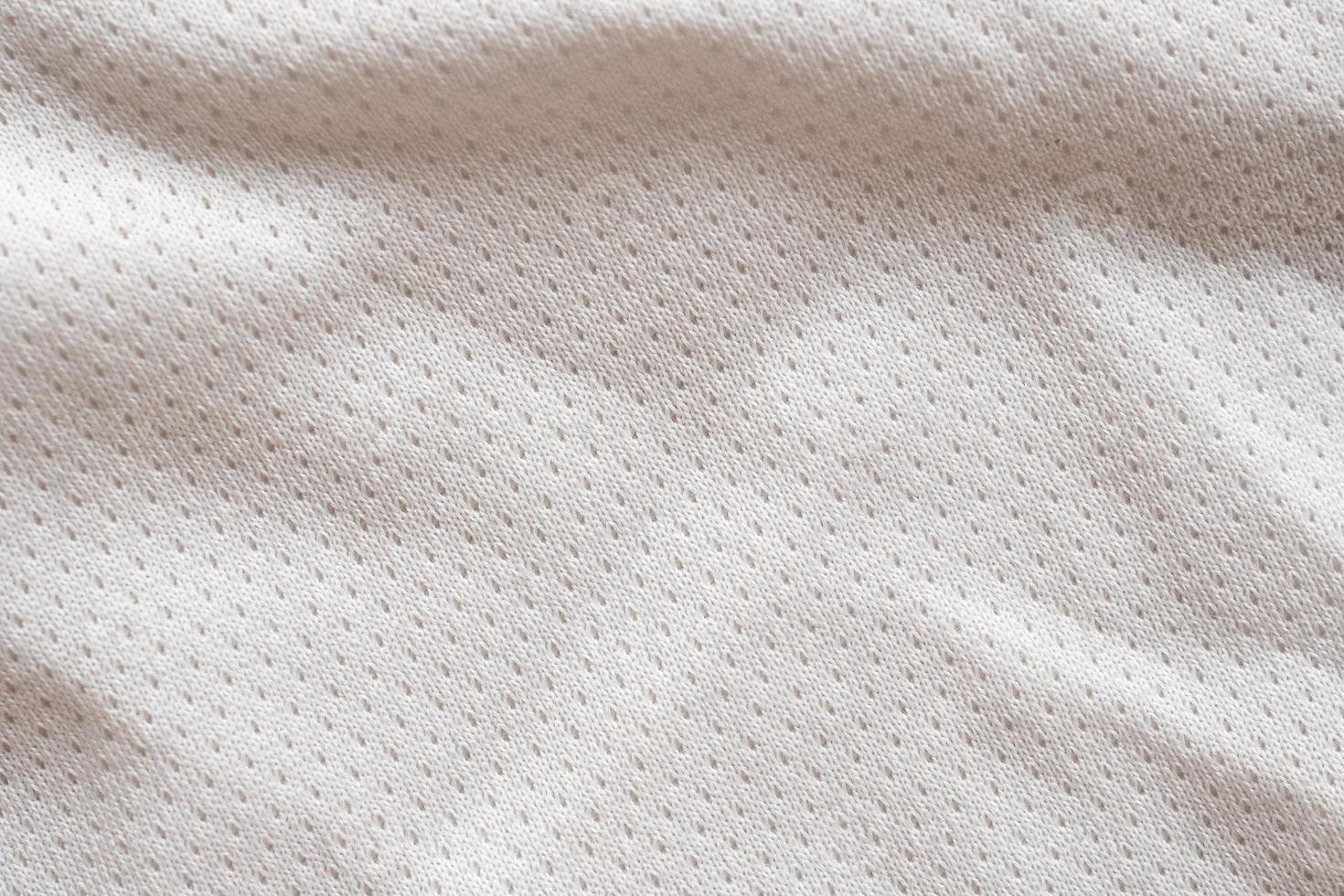 White fabric sport clothing football jersey with air mesh texture background photo