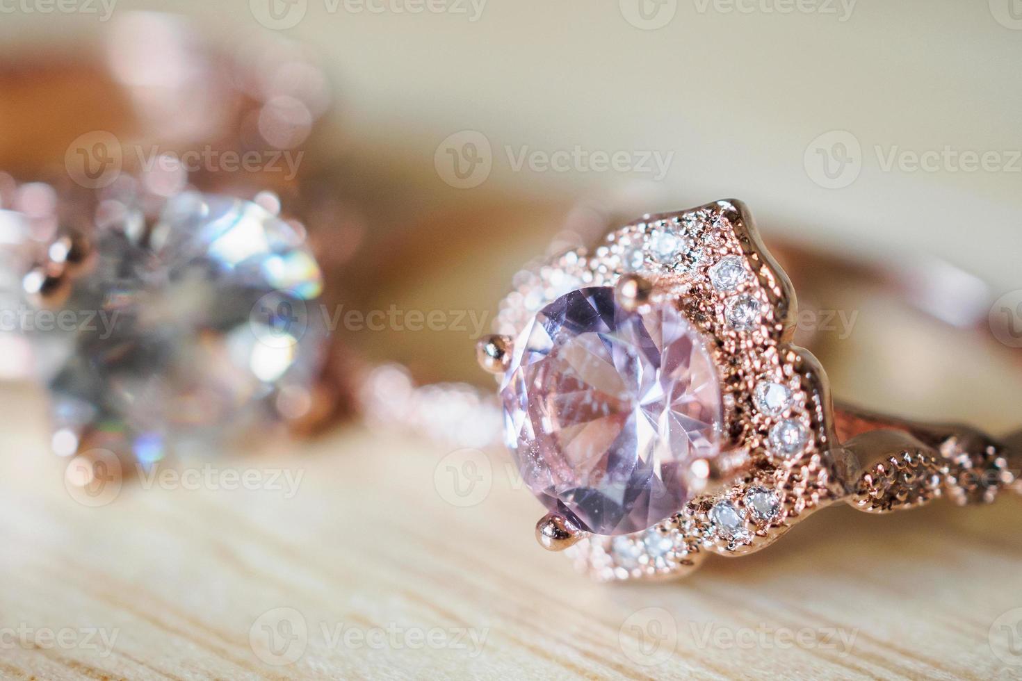 Jewelry pink sapphire rings on wood background photo