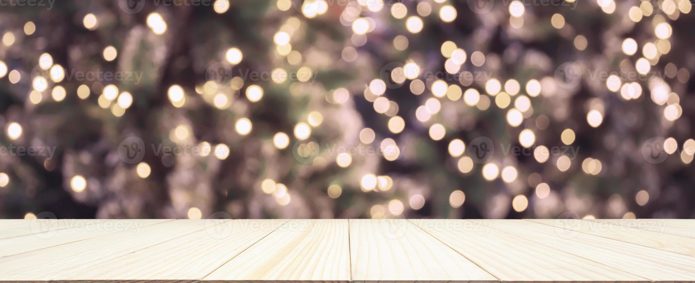 Empty wood table top with Abstract blur Christmas tree with decoration bokeh light background for product display photo