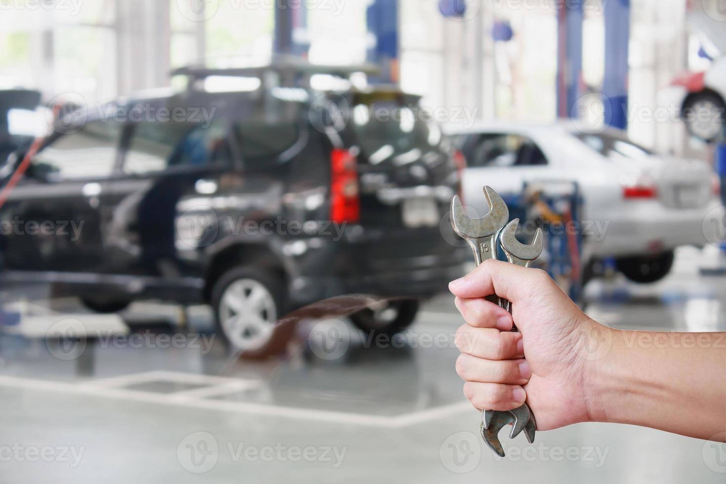 Hand of professional Auto mechanic with wrench photo