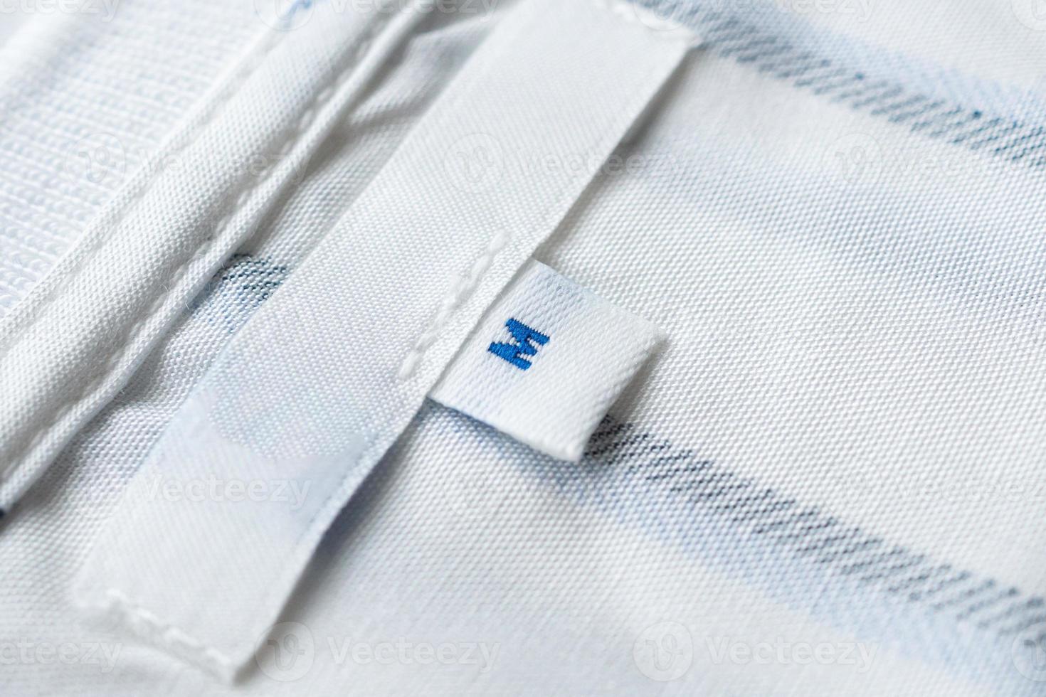 Blank white clothes label on new shirt photo