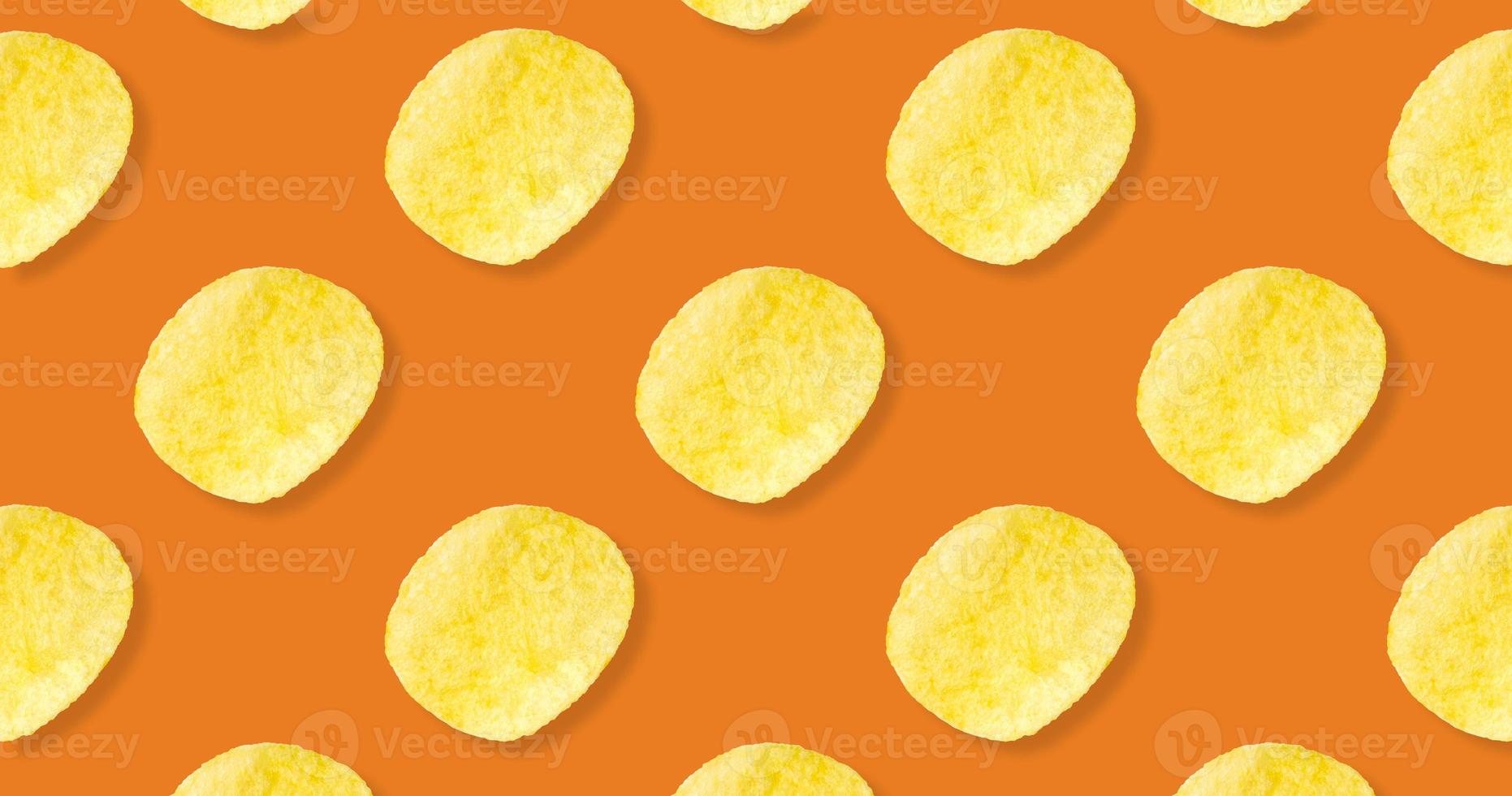 Potato chips pattern on pastel orange background top view flat lay photo